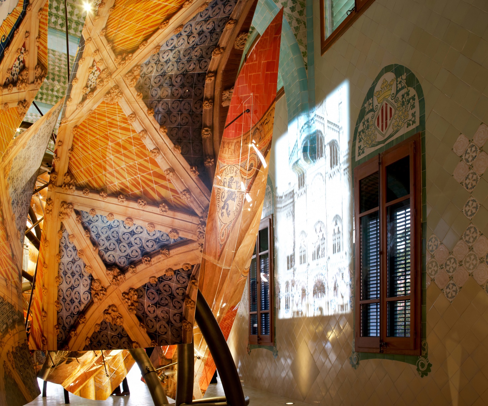 Hospital of the Santa Creu i Sant Pau. Illuminated dragon made of architectonic elements by Domènech i Montaner. Projection on the wall and window.